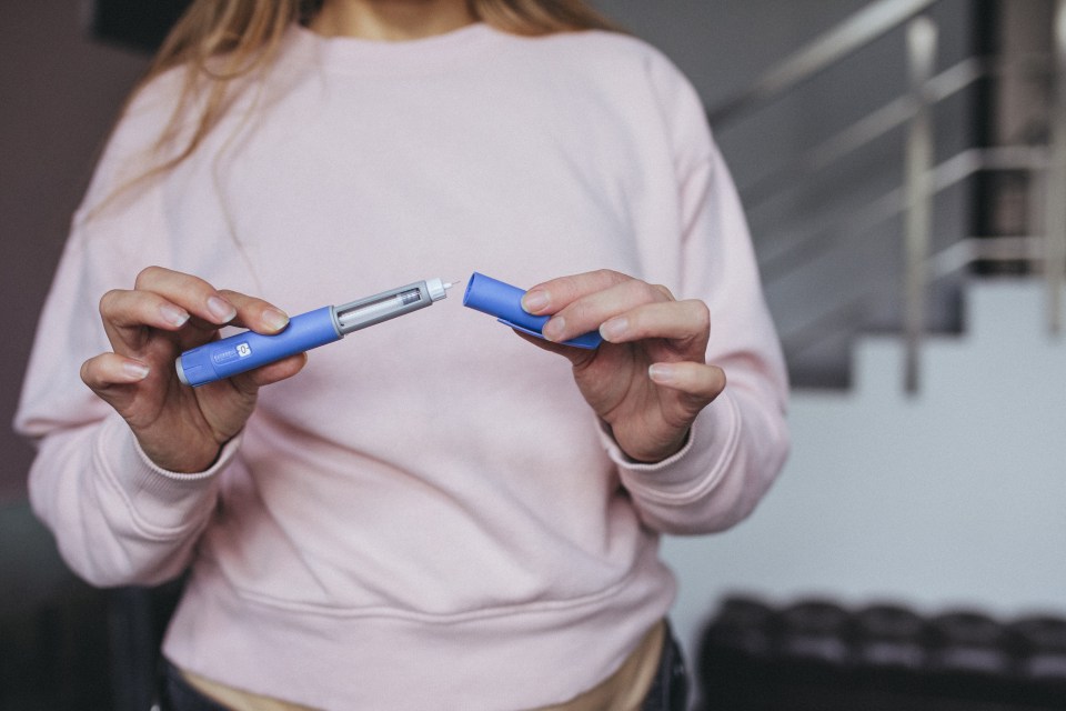 Woman preparing a semaglutide injection pen.