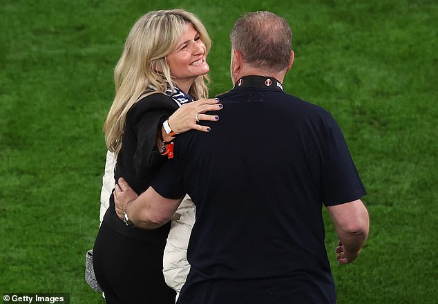 Tottenham boss Ange Postecoglou was embraced by his wife Georgia on the pitch post-match