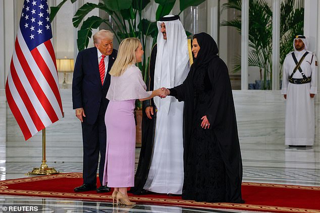 White House press secretary Karoline Leavitt wore a violet caped dress to Wednesday night's state dinner hosted by Qatar's Emir Tamim bin Hamad Al Thani