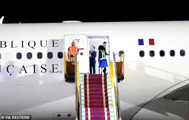 In video taken by The Associated Press as the Macrons arrived in Hanoi, Vietnam, on Sunday, a uniformed man can be seen pulling open the plane door and revealing the president standing inside, dressed in a suit and talking to someone who wasn't visible