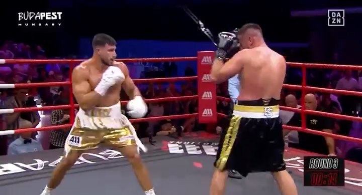 Two boxers facing each other in a boxing ring.