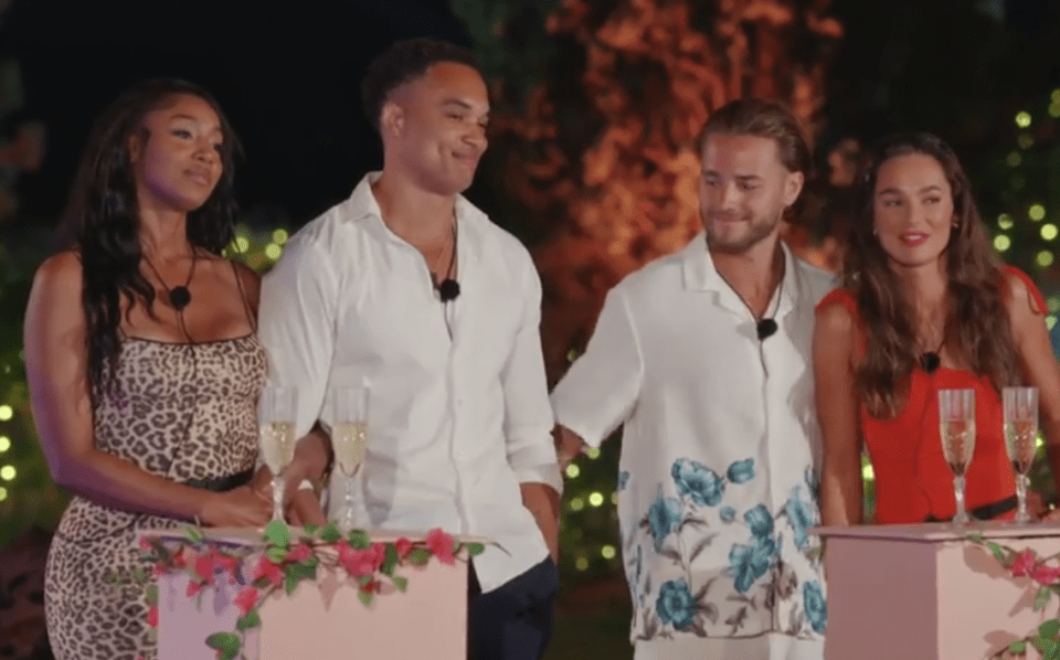 Screenshot of four people at a ceremony.
