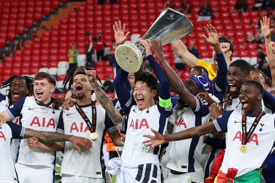 Heung-Min Son of Tottenham Hotspur lifts the UEFA Europa League trophy with his team.