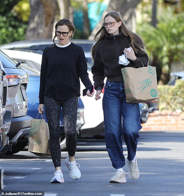The Yale student opted not to wear her usual facemask as she strode through the parking lot, a single bag from Whole Foods in her hand
