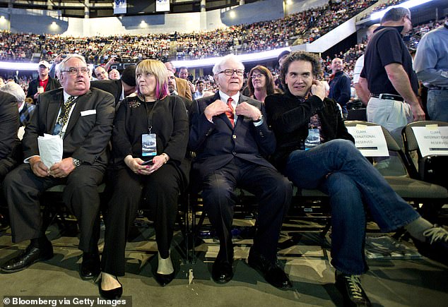 Buffett is seen here alongside his kids, from left to right, Howard, Susie and Peter at the annual meeting in 2011