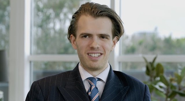 Portrait of a smiling man in a suit.