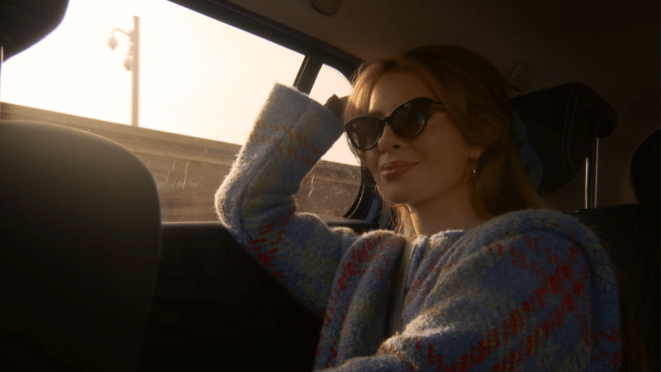 Woman wearing sunglasses in a car.