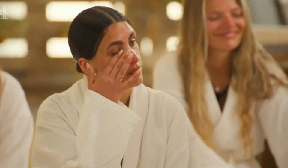 Woman crying in a white robe.