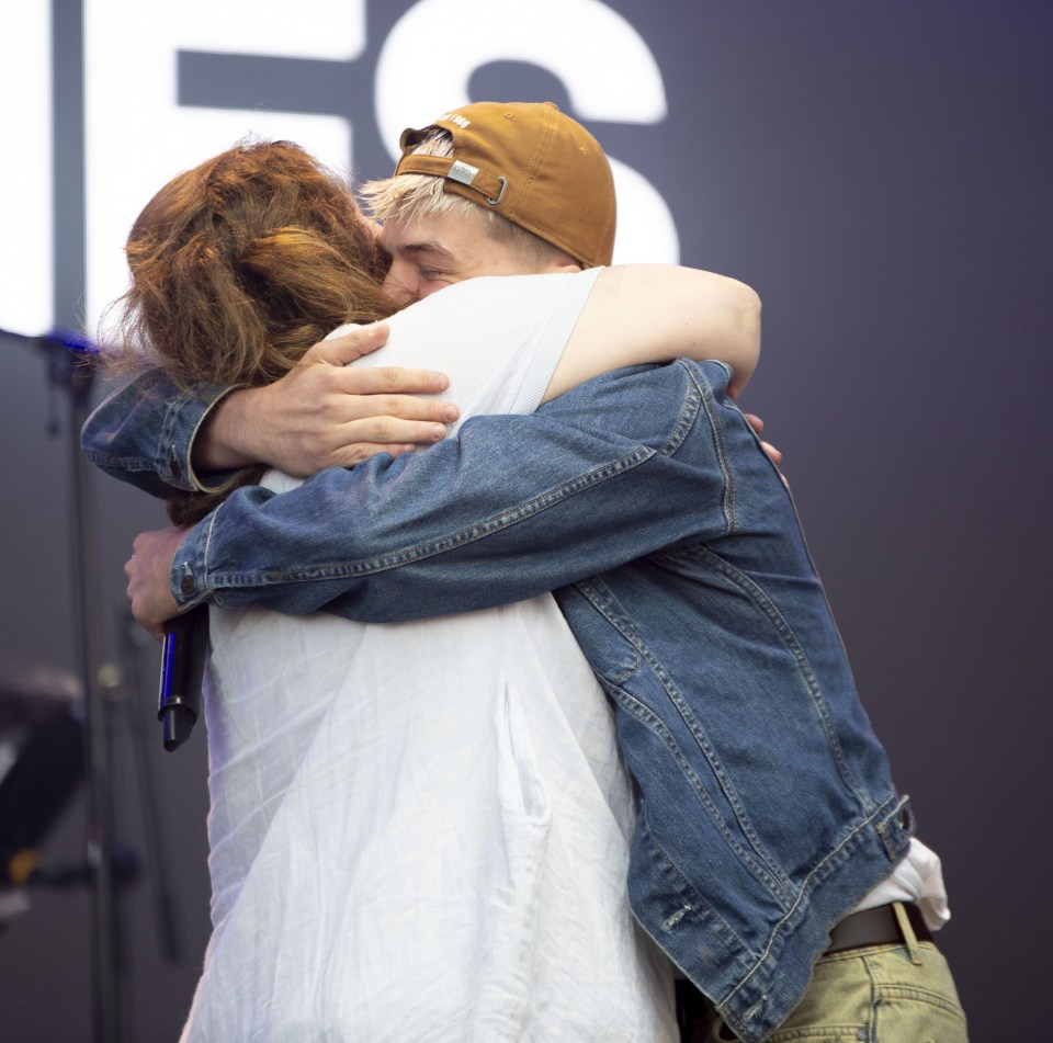 Ruth Jones and Oscar Hartland hugging at an awards festival.