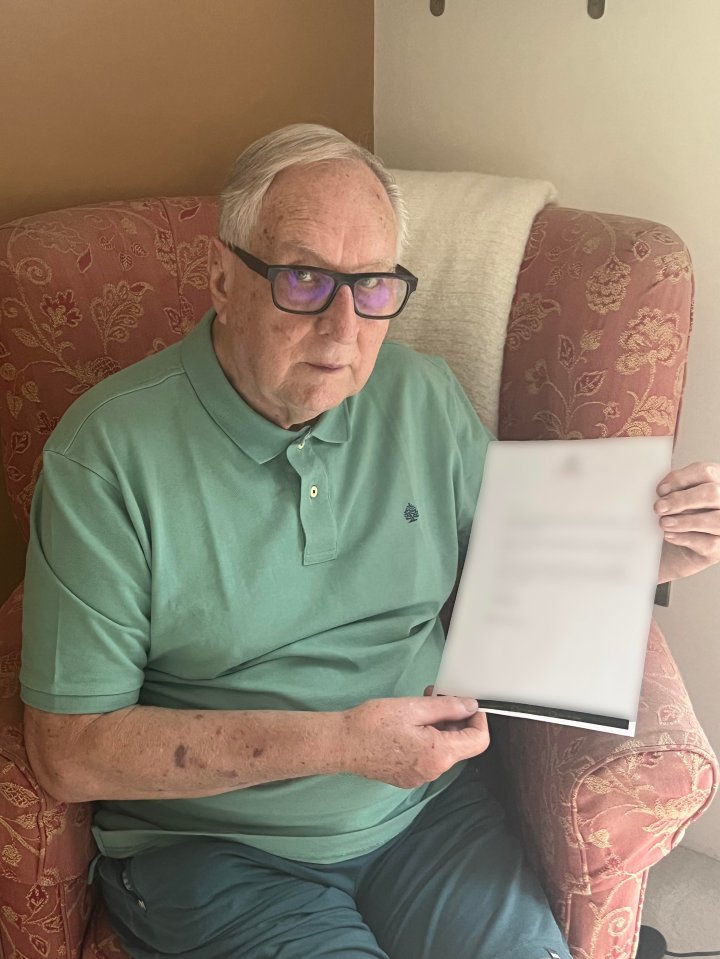 A man holds a document explaining that his cruise was cancelled due to post-Brexit passport rules.