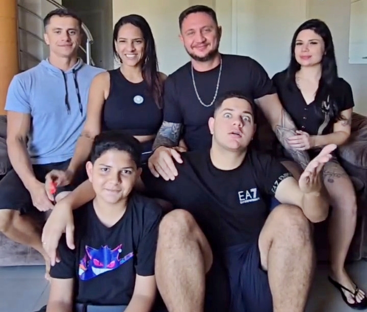 A polyamorous family of six posing for a photo.