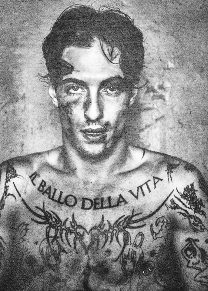 Black and white portrait of Damiano David with tattoos.