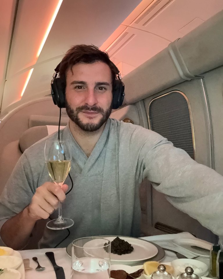 Man on private jet enjoying champagne and caviar.