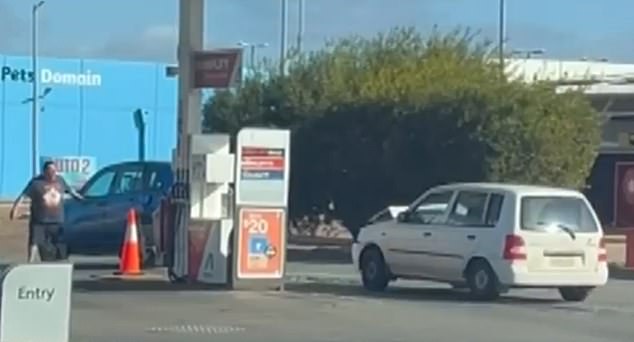 A man from a blue SUV was seen watching on helplessly as his car was repeatedly rammed
