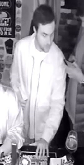 Black and white security camera image of a man police wish to speak to regarding a sexual assault.