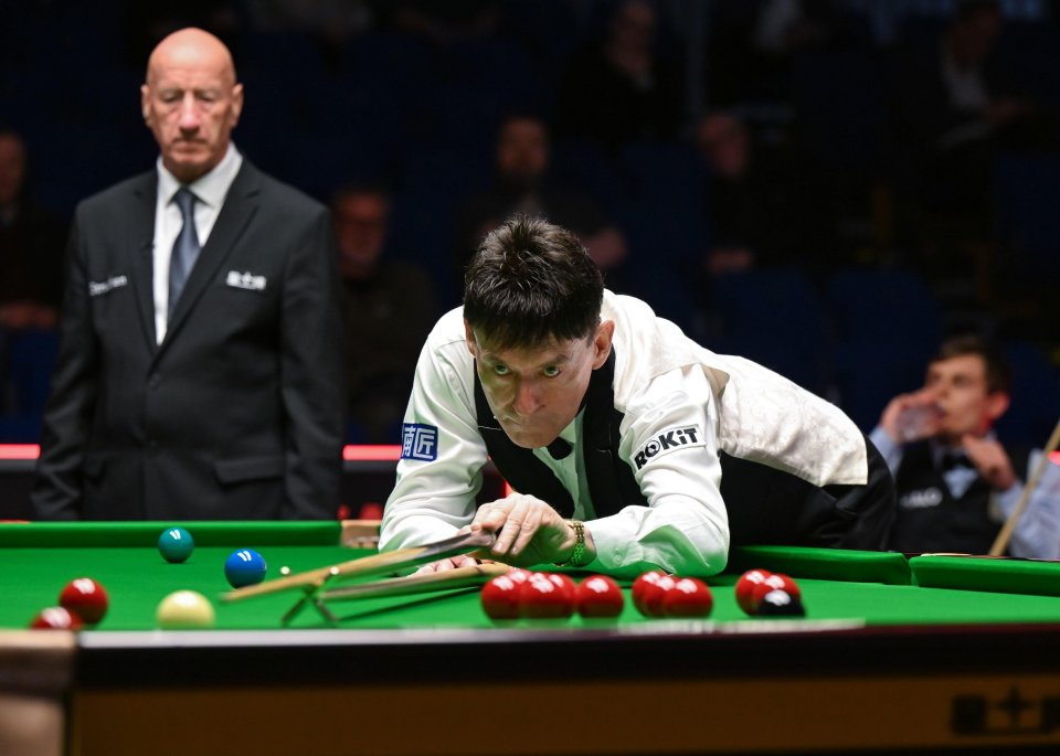 Jimmy White taking a shot during a snooker match.