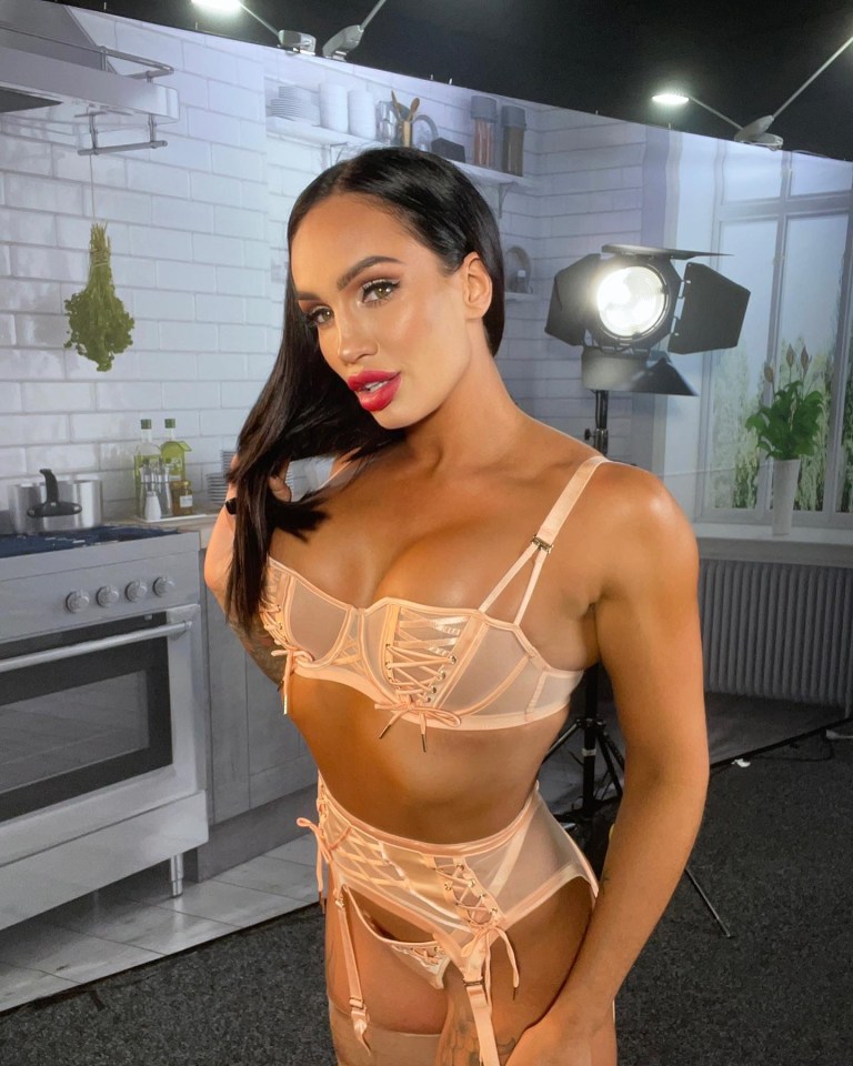 Woman in peach lingerie in a staged kitchen setting.