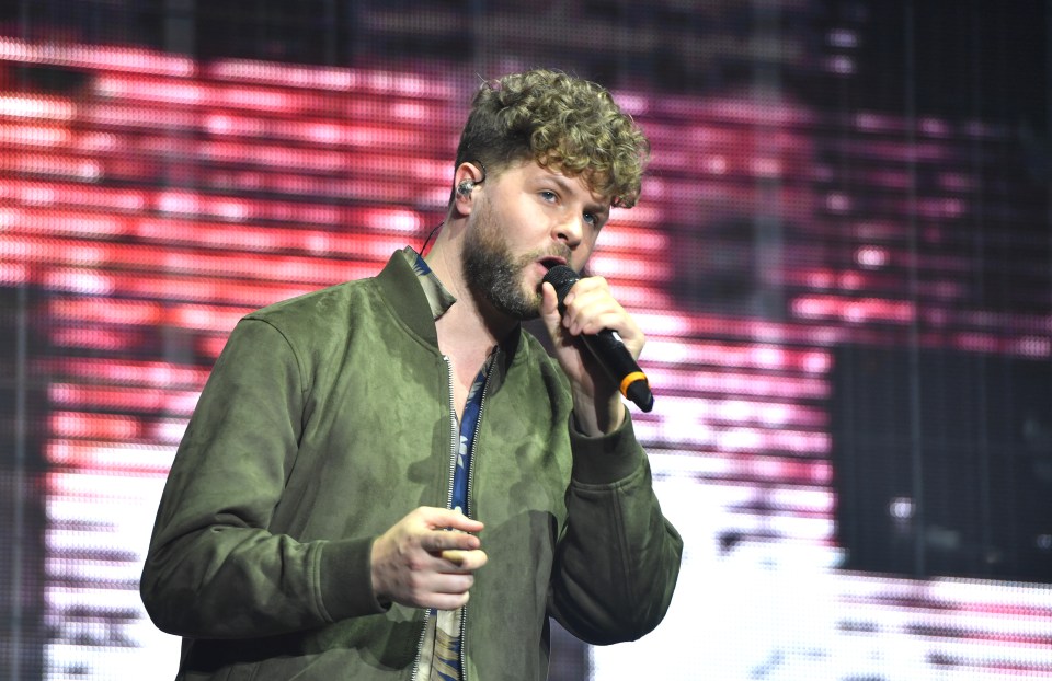 Jay McGuiness of The Wanted performing on stage.