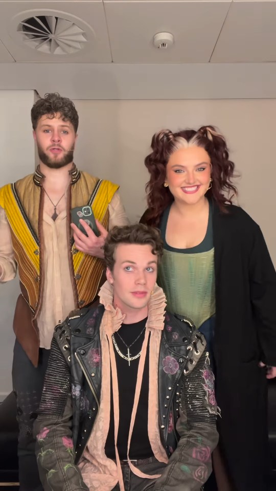 Three people in costume posing for a photo.