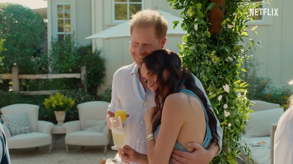 Prince Harry and Meghan Markle embracing outdoors.