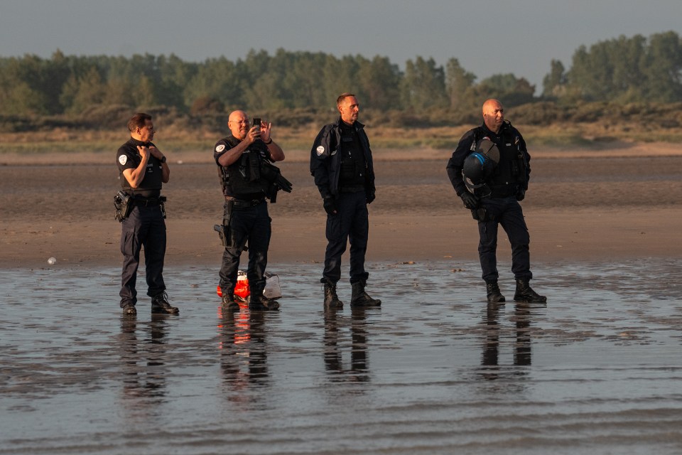 French police officers on a beach.