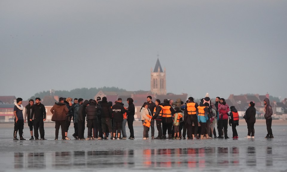 Migrants waiting on a beach in France to board a small boat to the UK.