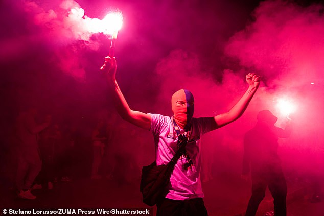 Masked hooligans burnt flares and chanted as they made their way through the streets leaving a trail of destruction in their wake