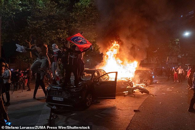 Burnt out cars were seen around Paris and outside the Parc des Princes thugs danced on cars in balaclavas, waving flags as they celebrated their football victory