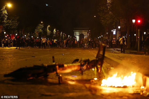 Bikes were set on fire as crowds walked along the Champs Elysees avenue near the Arc de Triomphe