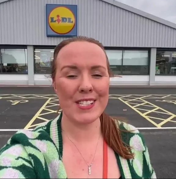 Woman in front of Lidl store sharing a tip.