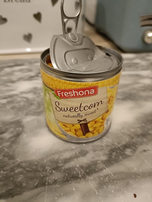A can of Fresona sweetcorn with the lid open.