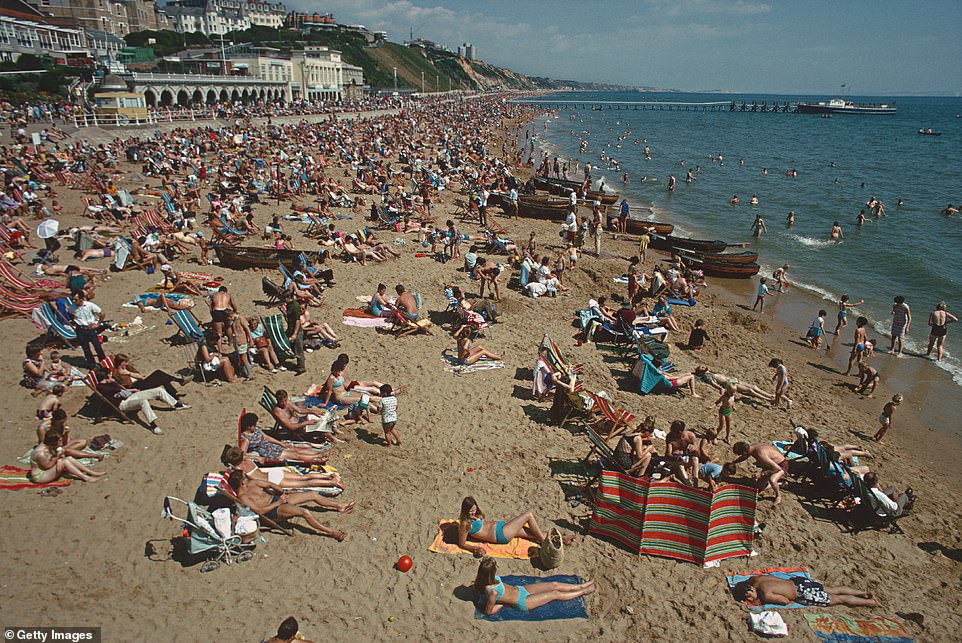 Crowds of holidaymakers are pictured on Bournemouth Beach in August 1970. Bournemouth remains a popular holiday destination today and its beach has frequently been recognised as the country's best