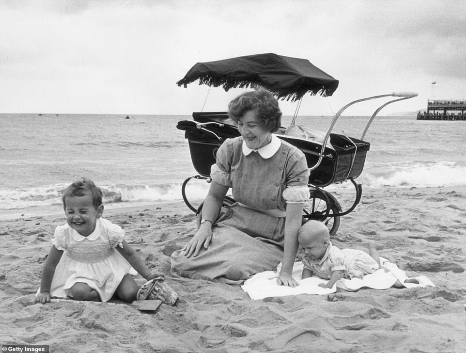 A nanny is photographed with the children in her care at the beach in Bournemouth on 1954. The photo's caption describes it as being taken on a 'rare sunny day'. Although Bournemouth escaped great damage during WWII, its popularity as a seaside resort began to decline in the 1950s