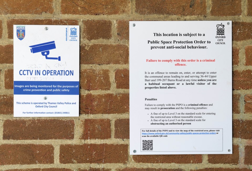 Two signs on a brick wall: one about CCTV in operation, the other about a Public Space Protection Order.