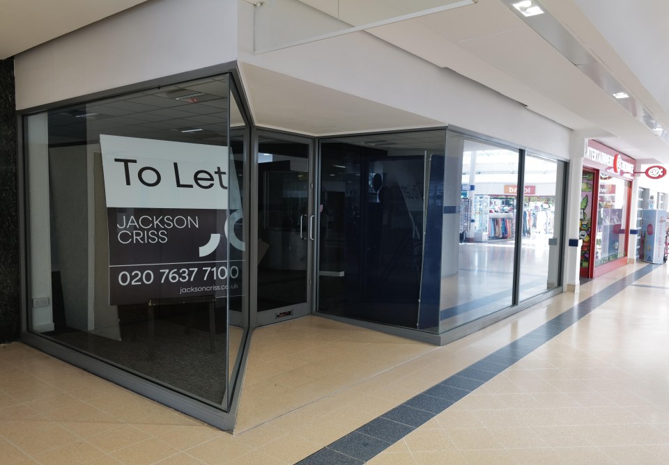 Empty storefront with "To Let" sign.
