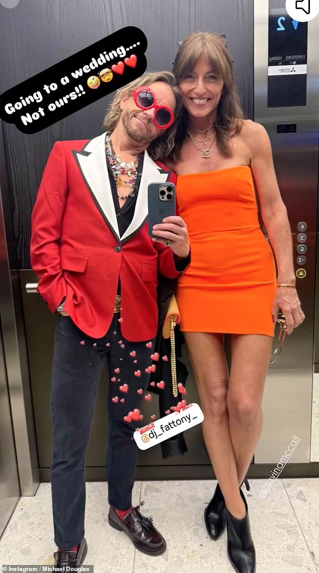 Davina McCall slipped into a colourful orange mini dress as she headed to the wedding with her partner Michael Douglas