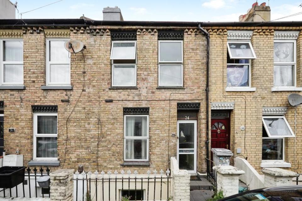Exterior view of a brick terraced house.