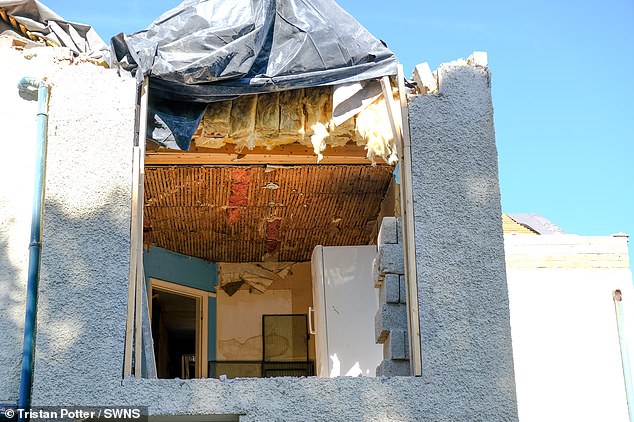 The detached property was left with its roof missing and rubble scattered all around it