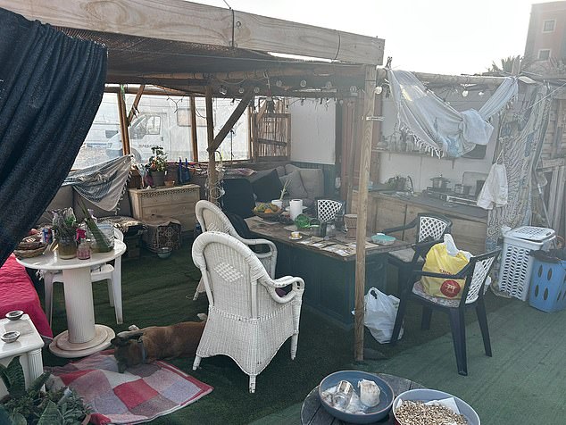 Pictured: Sharon's home, which a fellow resident on the site built for free using scrap wood, metal and a range of other materials