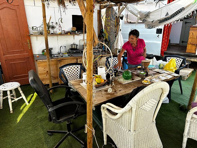 Inside Sharon's home is a kitchen worktop, portable stove, two sofas and a dining table and chairs