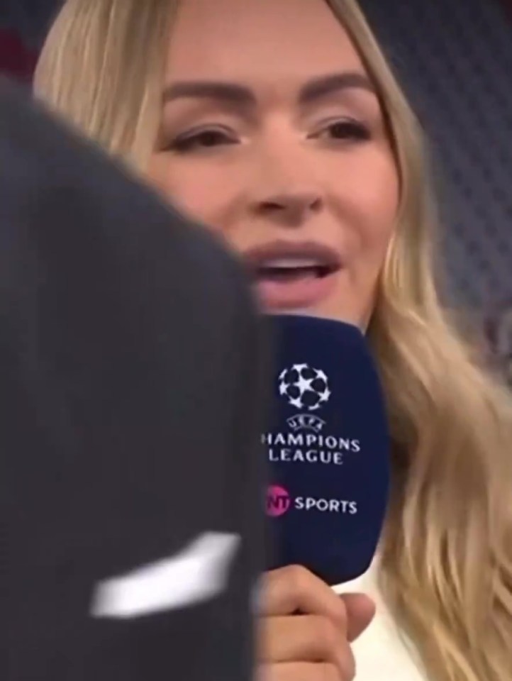 Laura Woods holding a Champions League microphone.
