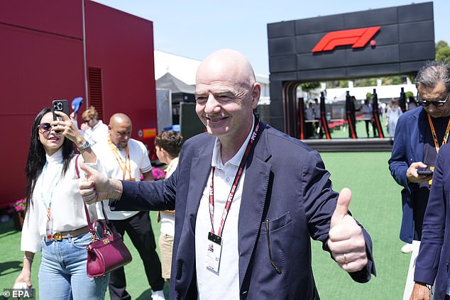 FIFA chief Gianni Infantino grinned while giving a double thumbs up gesture in the paddock