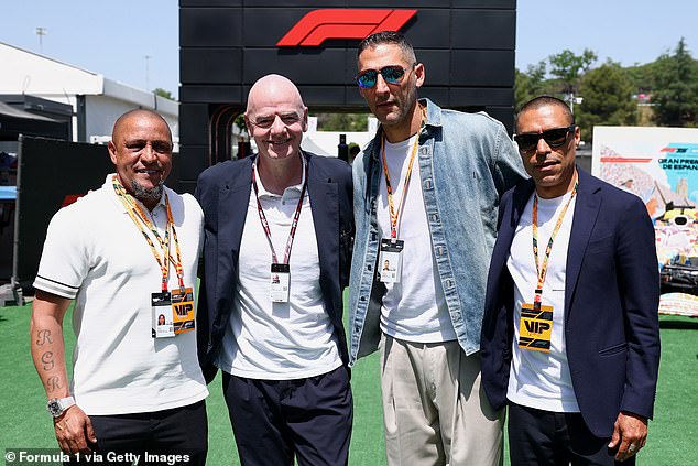 Infantino also posed for a photo with a host of iconic ex-players, including Roberto Carlos (left)