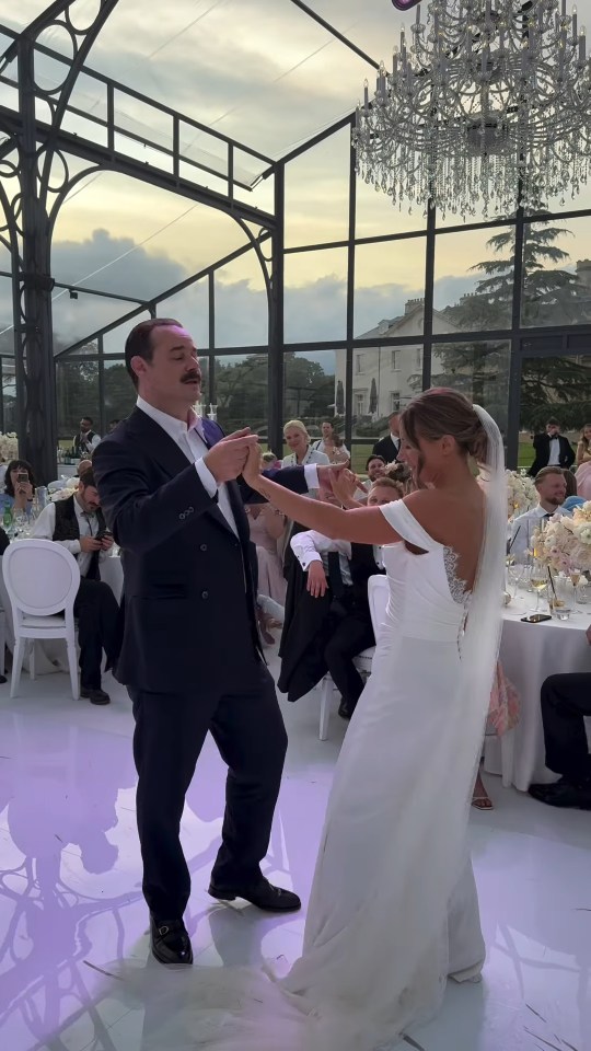 A bride and groom dancing at their wedding reception.