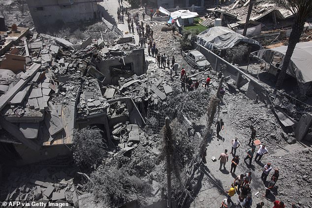 Palestinians inspect the rubble following Israeli strikes on the al-Qattaa family home in al-Tuffah neighbourhood in Gaza City on May 31, 2025