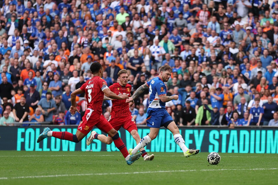 James Norwood of Oldham Athletic scoring a goal at Wembley Stadium.