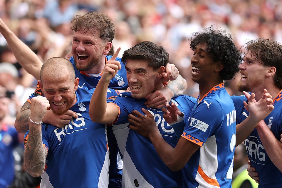 Oldham Athletic players celebrating a goal.