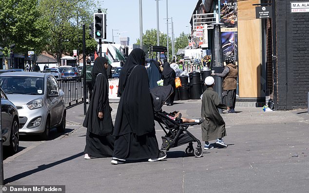 Women swathed in burqas in Small Heath - where 36.3 per cent of residents do not have English as their main language, while 15.9 per cent cannot speak English or speak it poorly