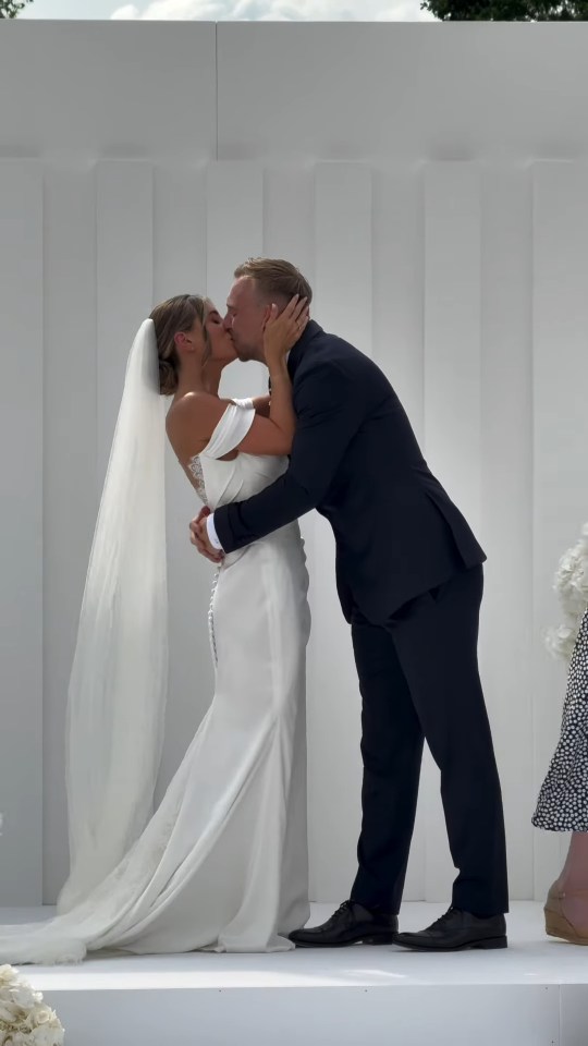 Bride and groom kissing at their wedding.