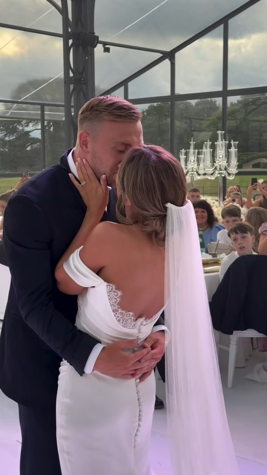 Bride and groom kissing at their wedding reception.
